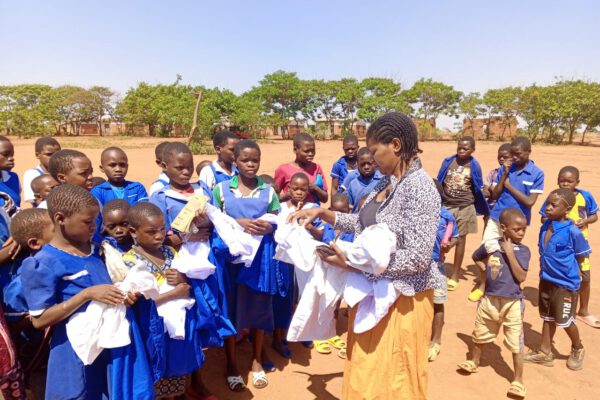 teacher giving uniforms