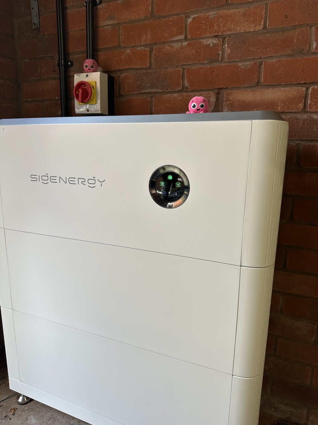 Sigenergy battery storage installed against a brick wall